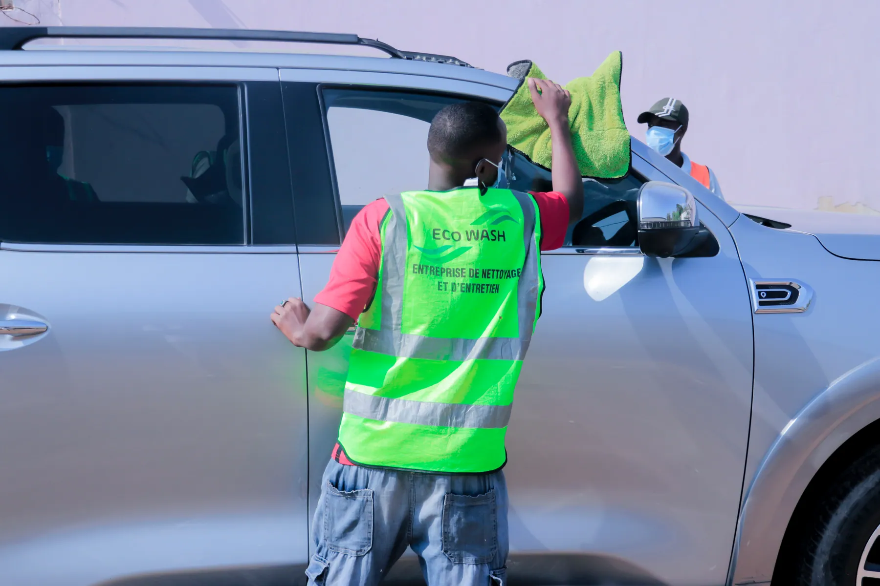 Technicien EcoWash nettoyant la carrosserie d’un véhicule sur place